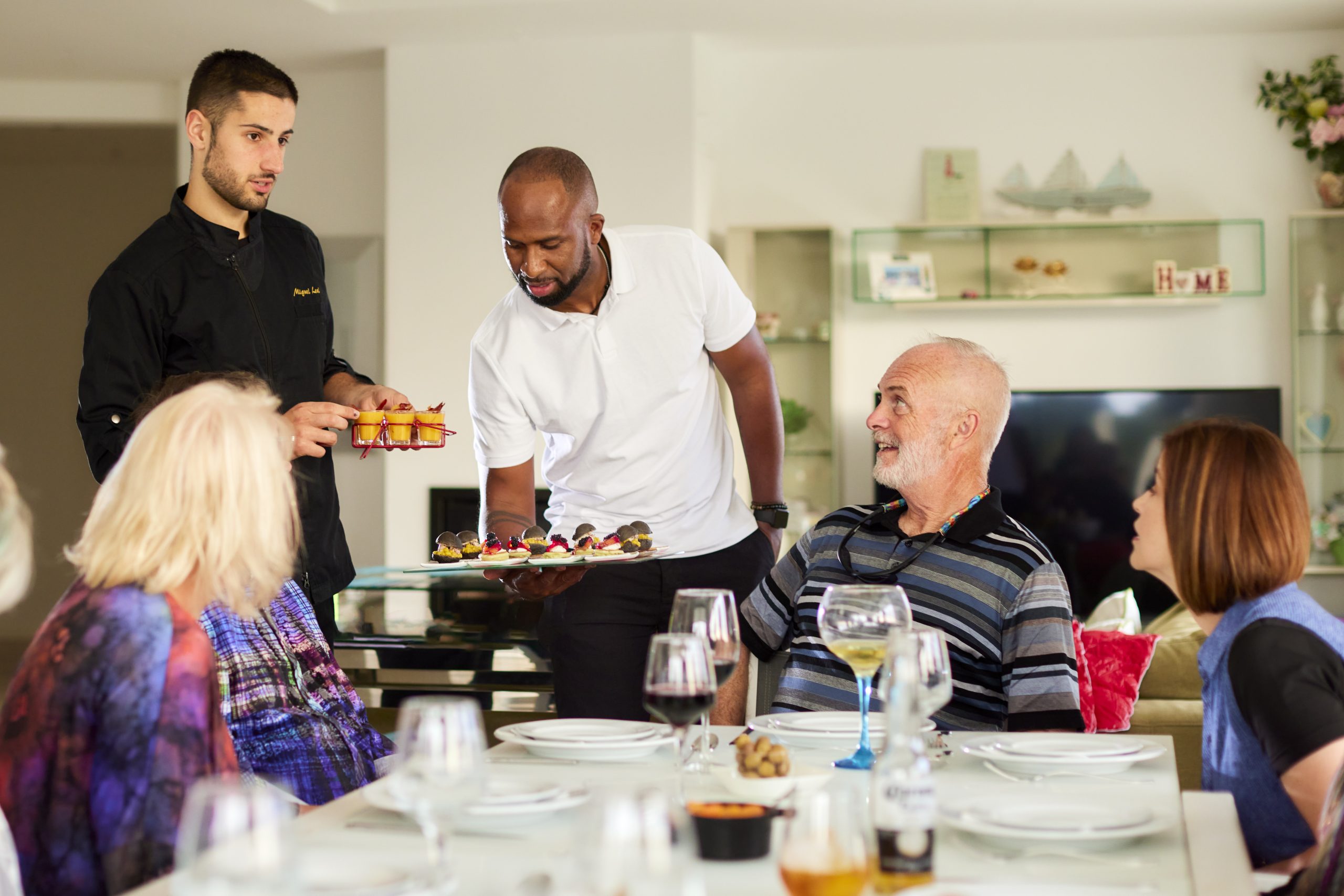 The Azure team presents a dish to a group of diners.